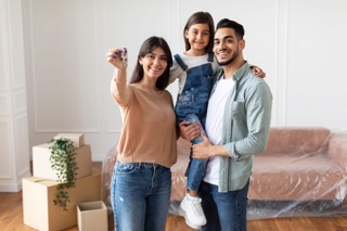 Smiling homeowners with their child